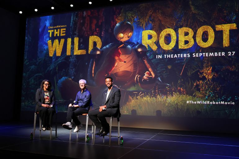 LOS ANGELES, CALIFORNIA - SEPTEMBER 25: (L-R) Jacqueline Coley, Chris Sanders, and Kris Bowers speak onstage during The Wild Robot Los Angeles screening and tastemaker event presented by DreamWorks Animation at Ross House on September 25, 2024 in Los Angeles, California. Leon Bennett/Getty Images for DreamWorks Animation/AFP (Photo by Leon Bennett / GETTY IMAGES NORTH AMERICA / Getty Images via AFP)